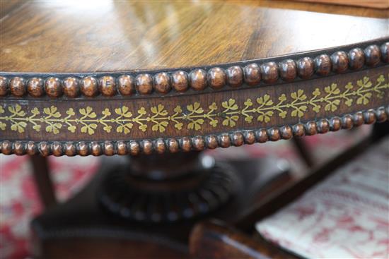 An early 19th century rosewood and brass inlaid breakfast table, Diam. 4ft